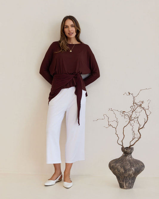 Image of a model wearing Tops. Product name - Gina Long Sleeved Bamboo Top Burgundy in Burgundy colour by brand - Lou Lou