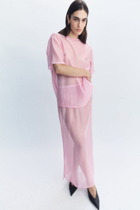 Image of a model wearing Skirts. Product name - Cora Skirt Pink in Pink colour by brand - Blanca Studio