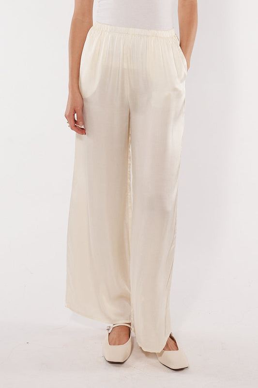 Image of a model wearing Pants. Productname: Cowgirl Surfer Eze Pant Cream in Cream colour by brand - Cowgirl Surfer