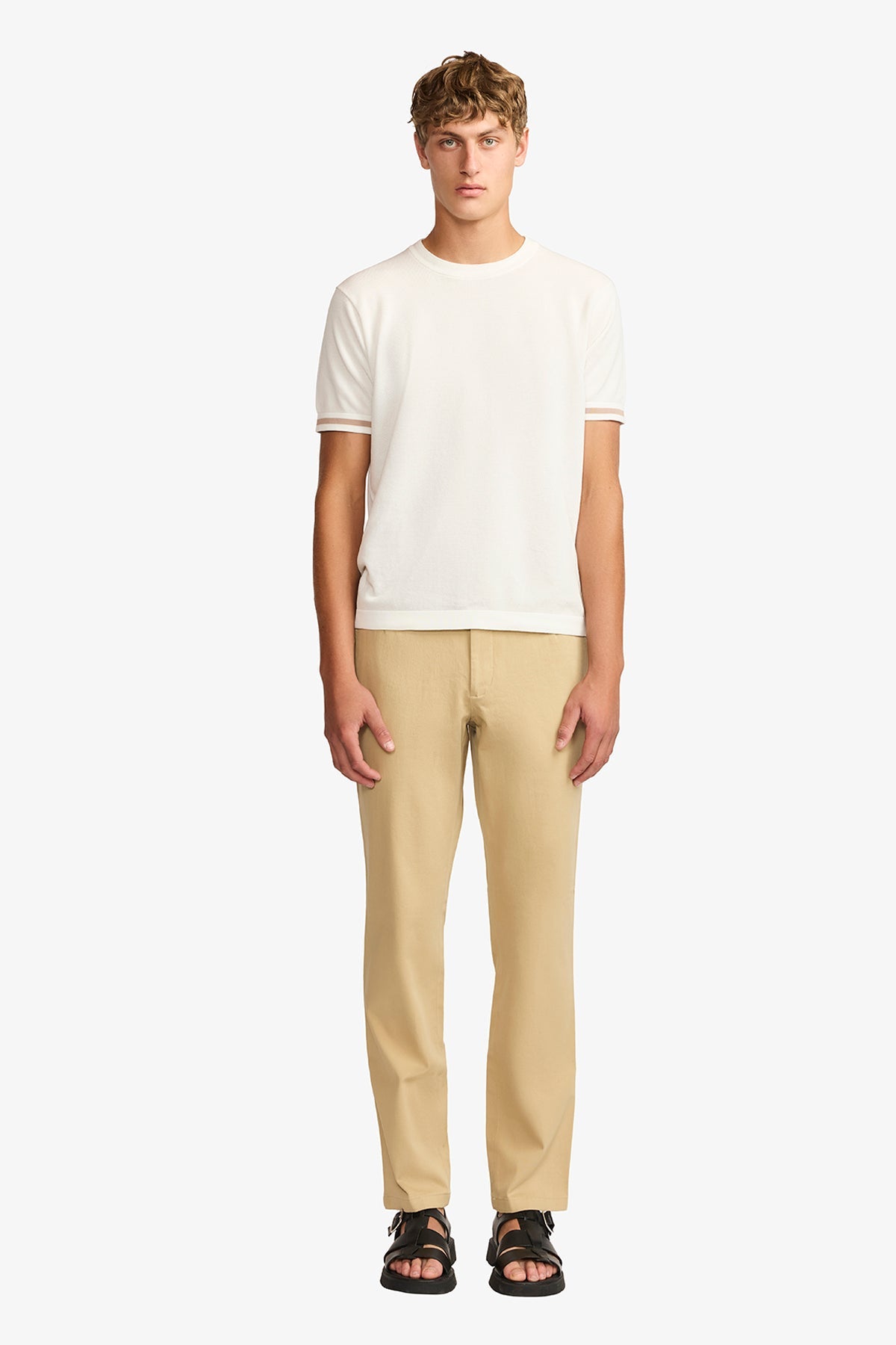 Image of a model wearing Pants. Product name - Austin + Tan Chino in Tan colour by brand - Anthony Squires