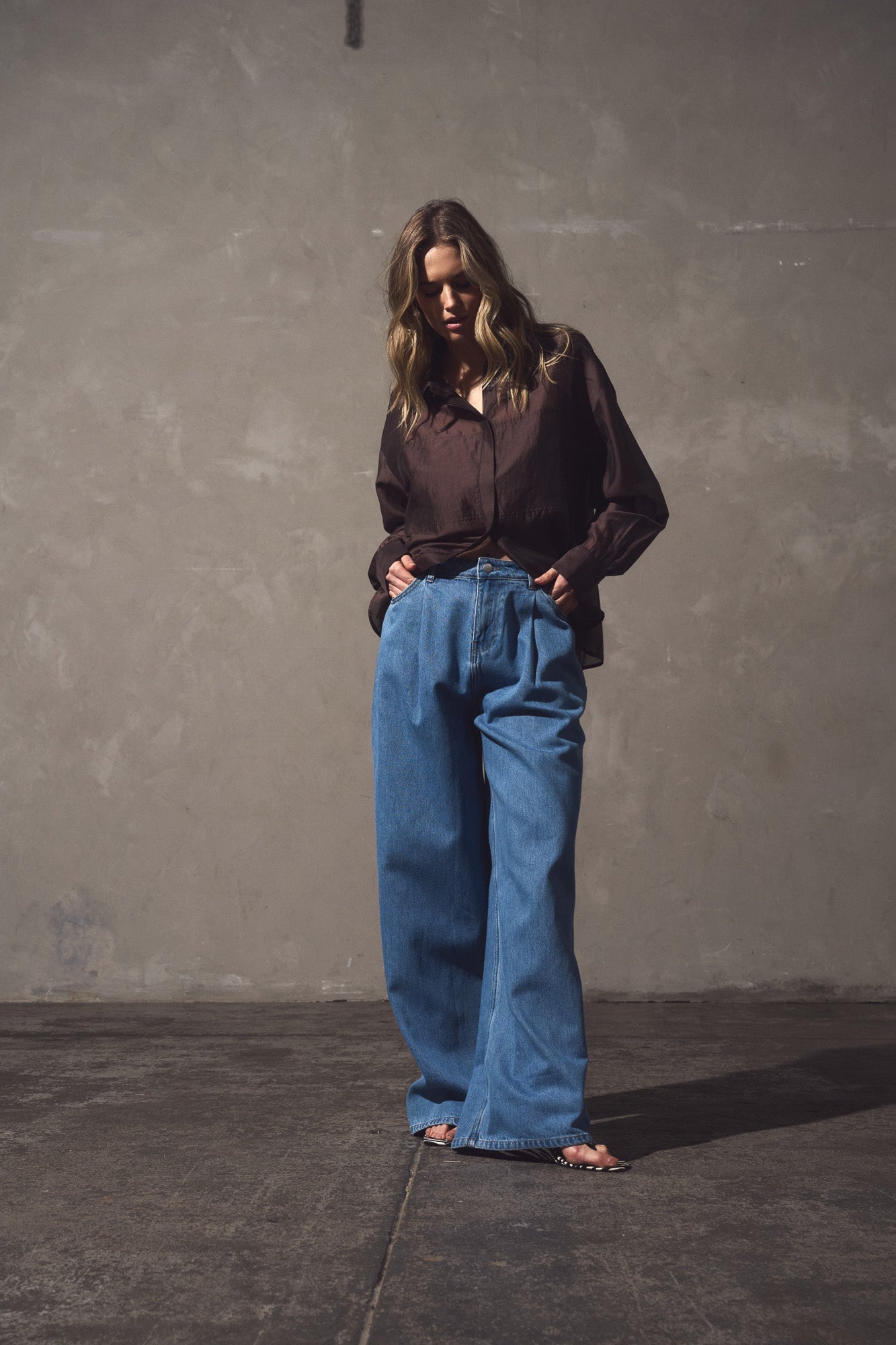 Image of a model wearing Pants. Product name - Yara Slack Pleat Jean Classic Blue Wash in Classic Blue Wash colour by brand - Sass Clothing