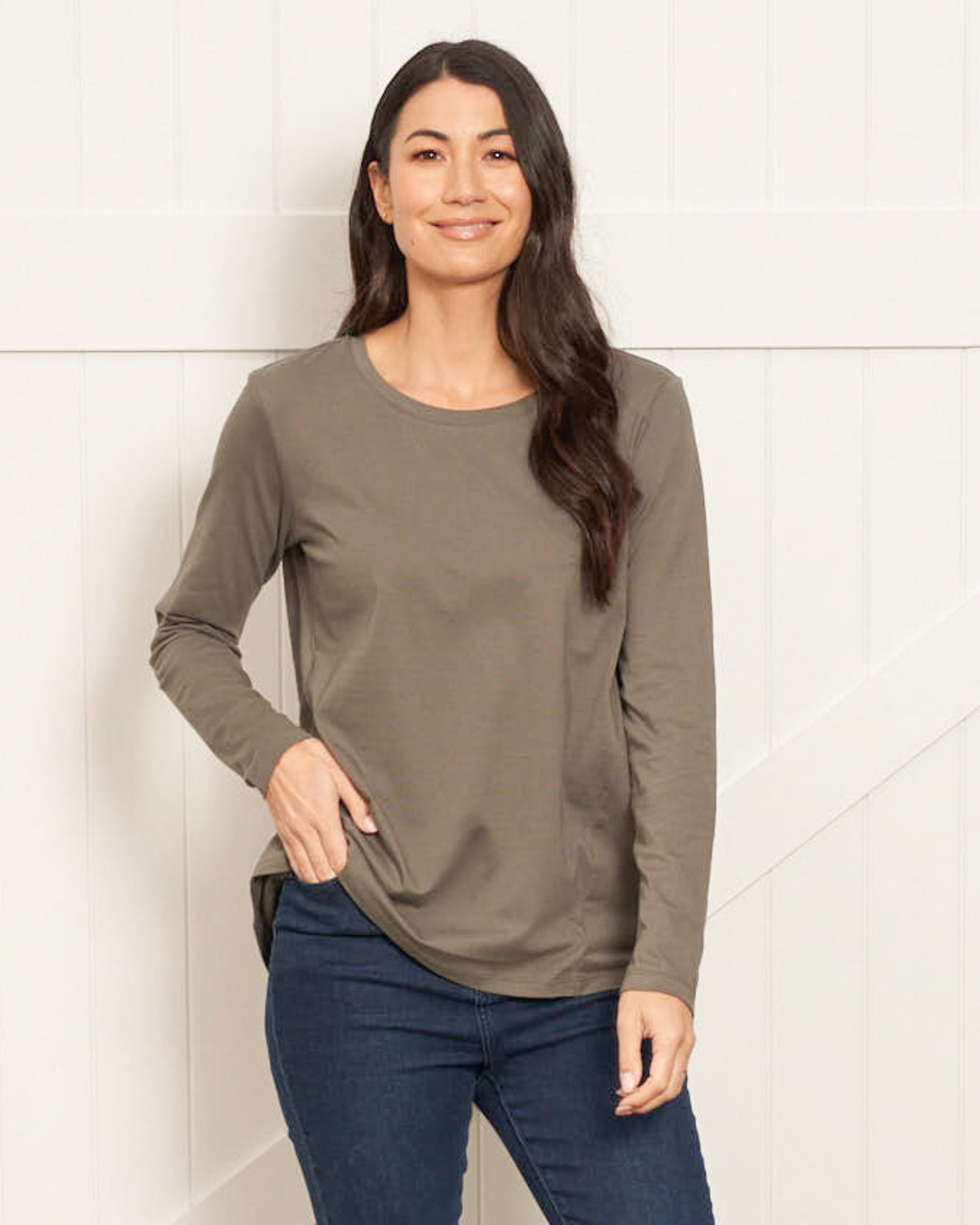 Image of a model wearing Tops. Productname: Betty Basics Sydney 100% Australian Cotton Relaxed Trapeze Basic Long Sleeve Tee Ash Green in Ash Green colour by brand - Betty Basics