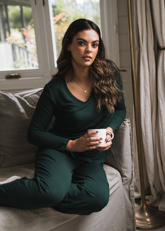 Image of a model wearing Tops. Product name - Sia V Neck Bamboo Longsleeve Top Dark Green in Dark Green colour by brand - Lou Lou