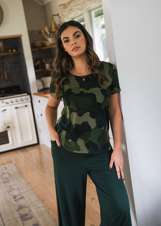 Image of a model wearing Tops. Product name - Janis Short Sleeve Bamboo T-Shirt Camouflage Print in Camouflage colour by brand - Lou Lou