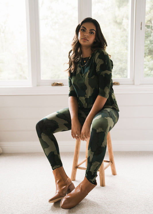 Image of a model wearing Tops. Product name - Camila 3/4 Sleeve Bamboo Top Camouflage Print in Camouflage colour by brand - Lou Lou