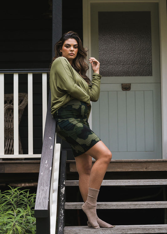 Image of a model wearing Skirts. Product name - Midi Bamboo Whitney Tube Skirt Camouflage in Camouflage colour by brand - Lou Lou