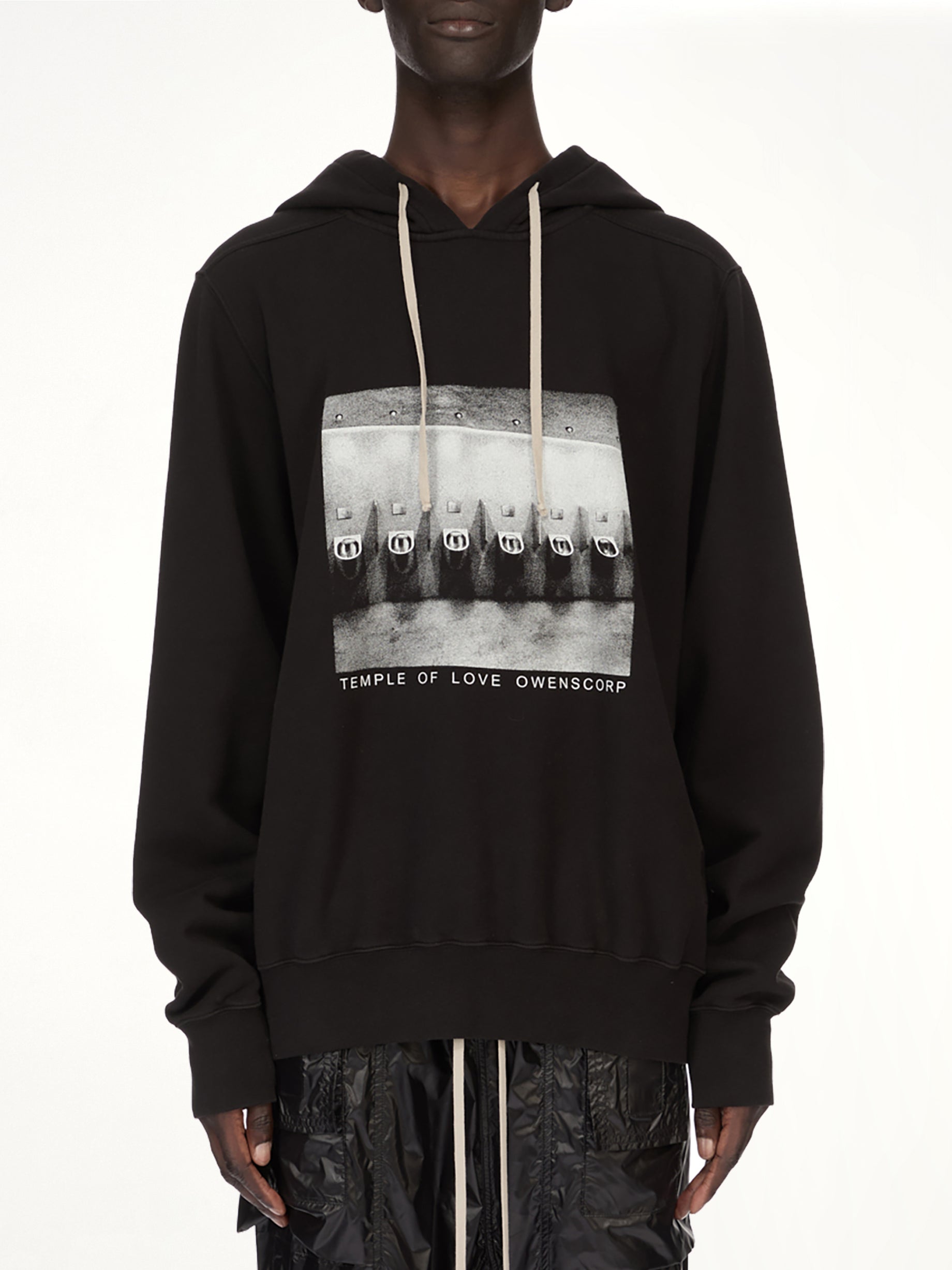 Image of a model wearing Outerwear. Product name - Urinal Oversized Hoodie in Black colour by brand - RICK OWENS DRKSHDW