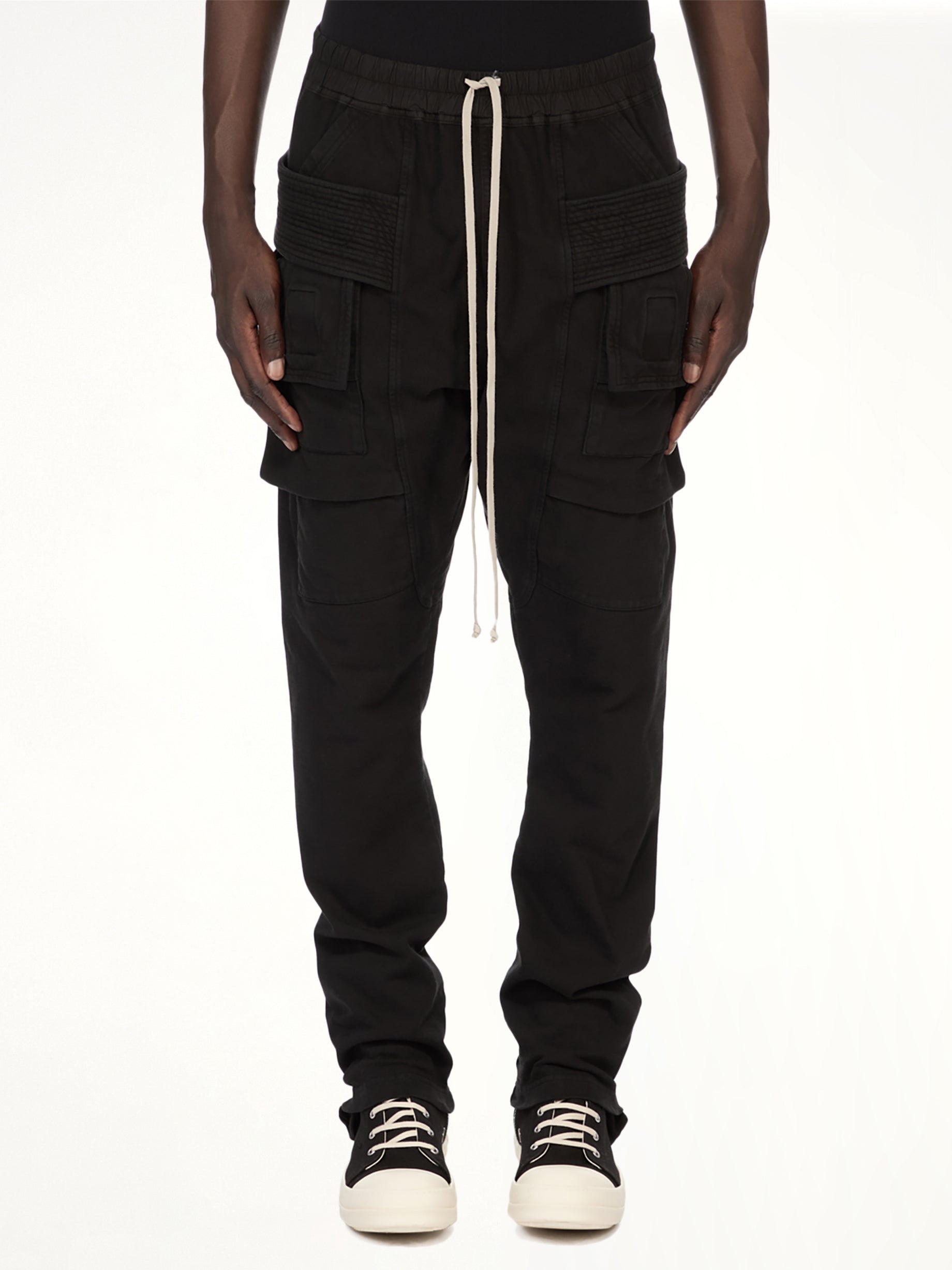 Image of a model wearing Pants. Product name - Creatch Cargo Drawstring in Black colour by brand - RICK OWENS DRKSHDW
