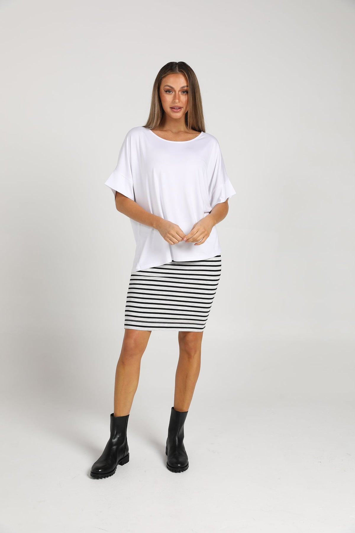 Image of a model wearing Tops. Product name - Demi Oversized Bamboo Box T-Shirt in Black colour by brand - Lou Lou