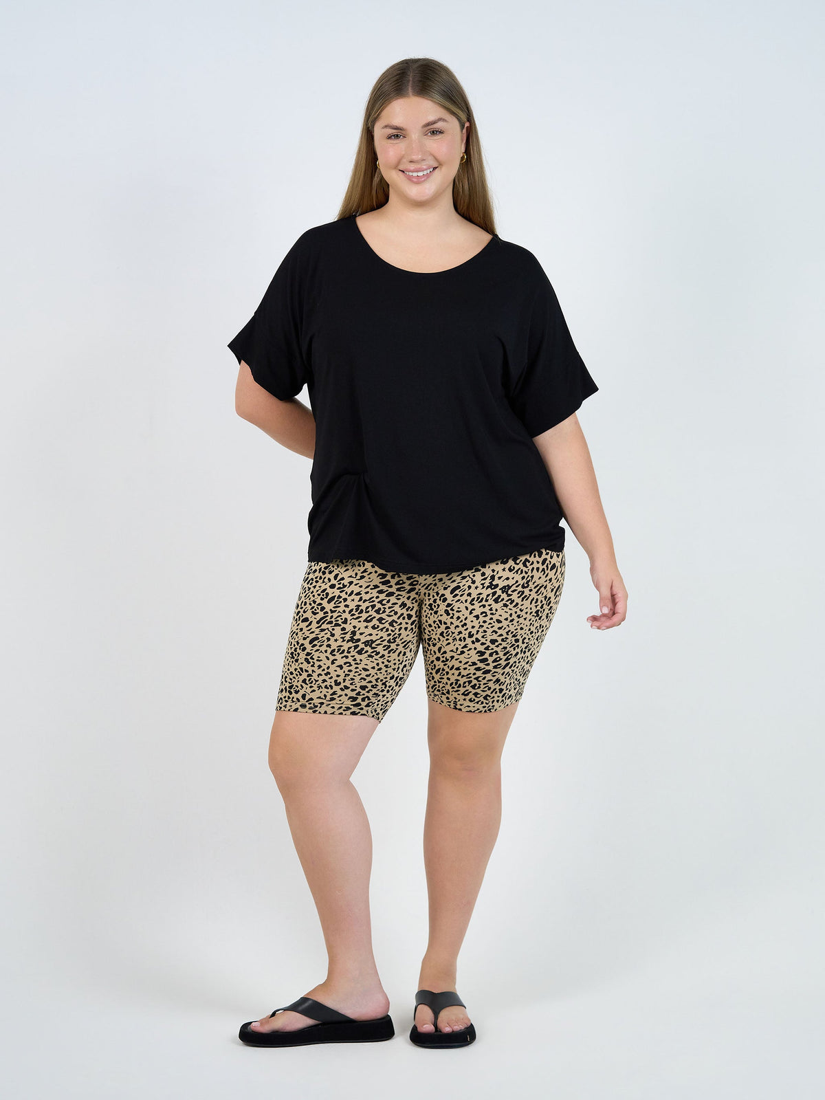 Image of a model wearing Tops. Product name - Demi Oversized Bamboo Box T-Shirt Black in Black colour by brand - Lou Lou