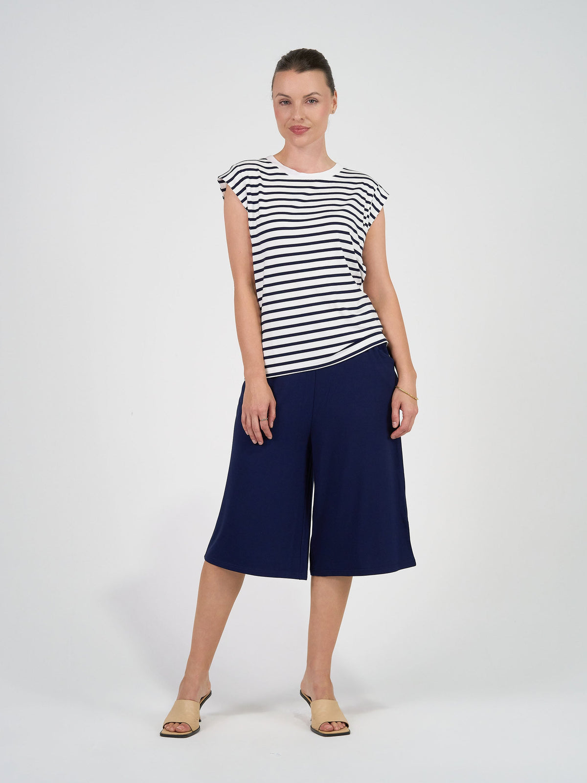 Image of a model wearing Tops. Product name - Donna Cap Sleeve Bamboo Tee Navy & White Stripe in Navy & White Stripe colour by brand - Lou Lou
