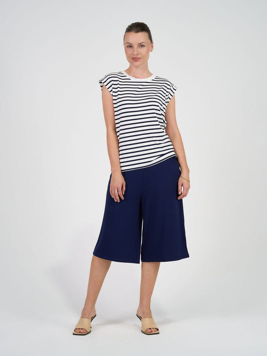 Image of a model wearing Tops. Product name - Donna Cap Sleeve Bamboo Tee Navy & White Stripe in Navy & White Stripe colour by brand - Lou Lou
