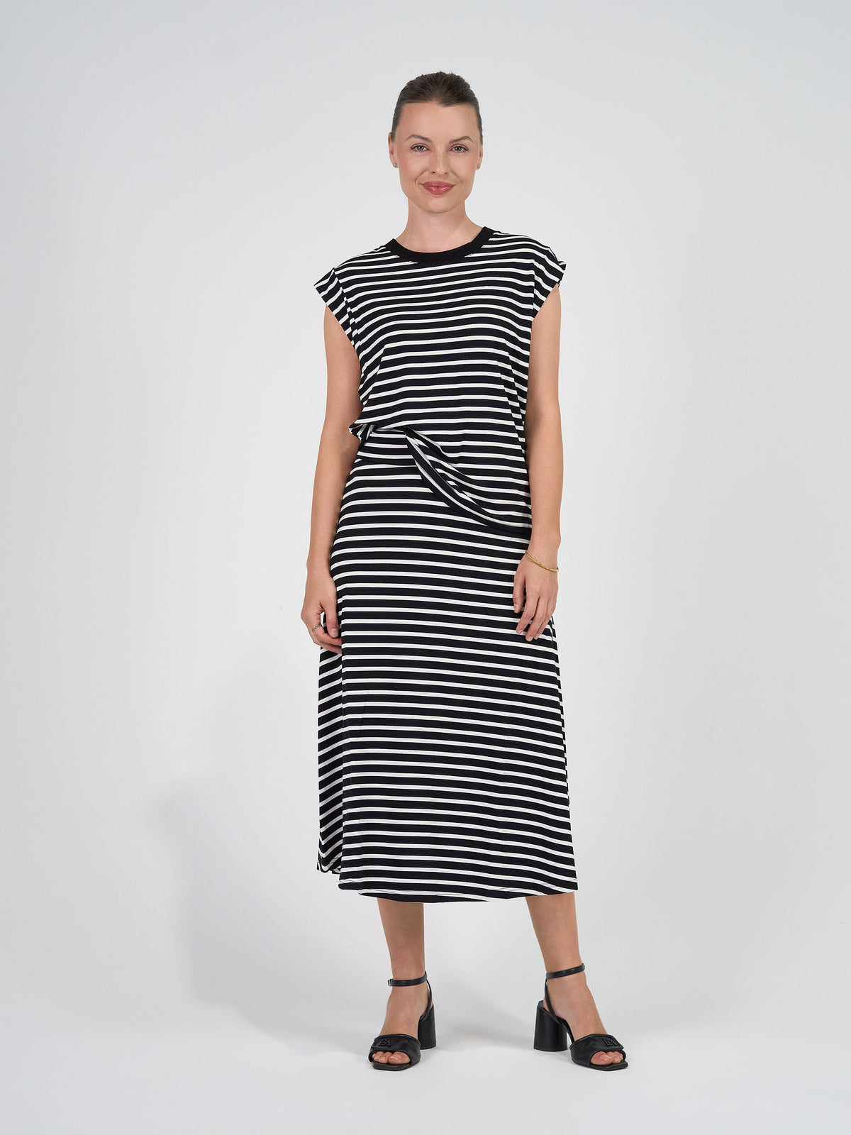 Image of a model wearing Tops. Product name - Donna Cap Sleeve Bamboo Tee Black & White Stripe in Black & White Stripe colour by brand - Lou Lou