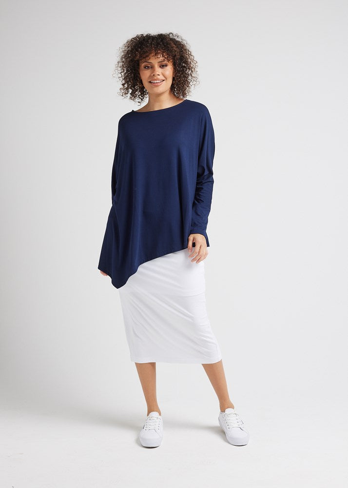 Image of a model wearing Tops. Product name - Susie Oversized Asymmetrical Bamboo Top Navy in Navy colour by brand - Lou Lou
