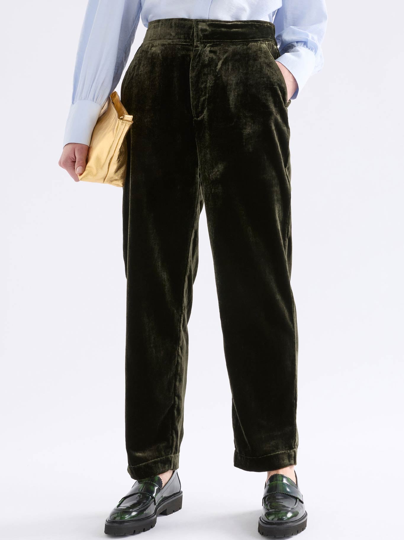 Image of a model wearing Pants. Product name - Elk Suuri Velvet Pant in Olive colour by brand - Elk