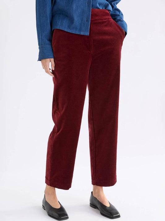 Image of a model wearing Pants. Product name - Elk Altes Pant in Merlot colour by brand - Elk