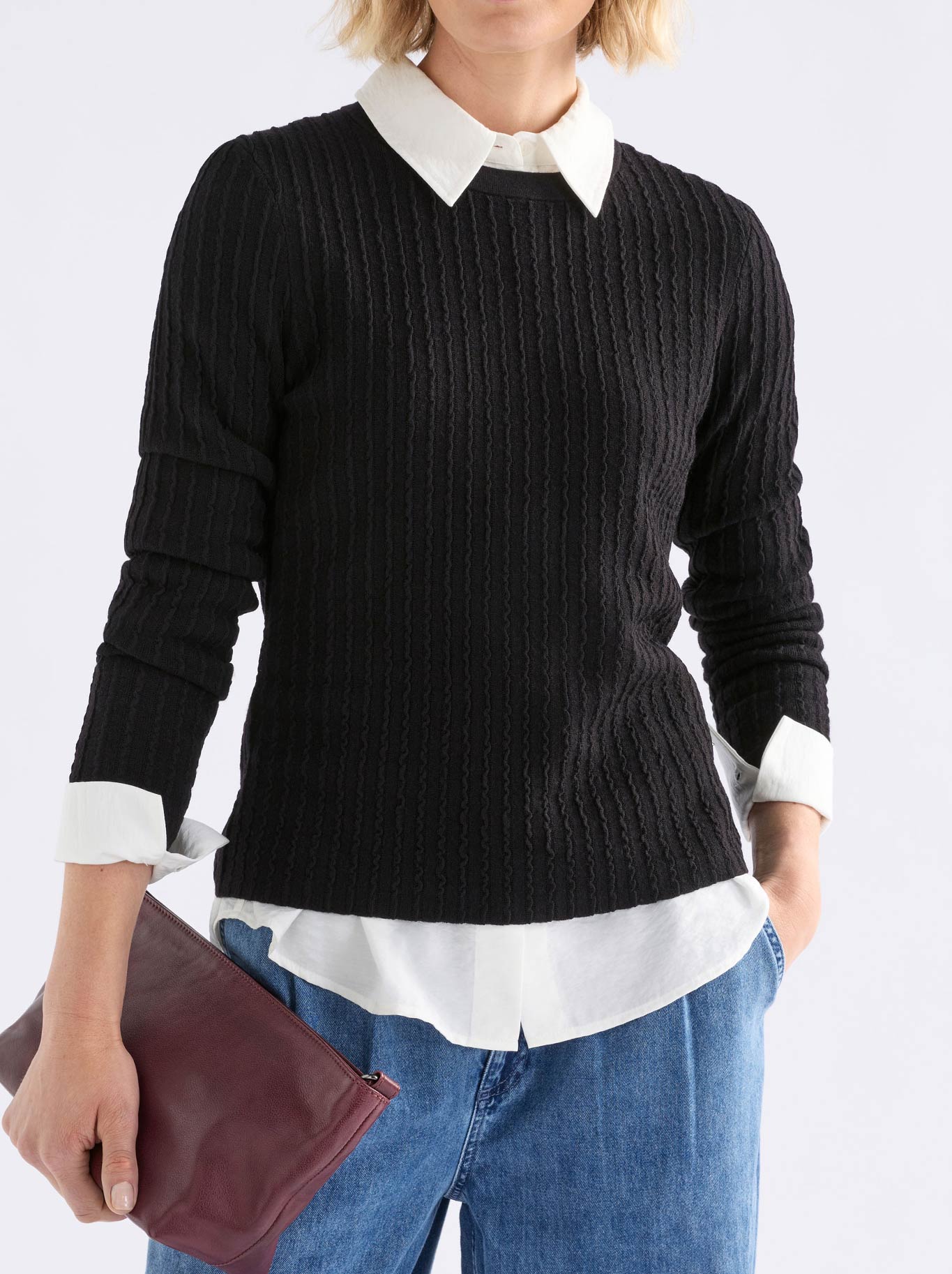 Image of a model wearing Outerwear. Product name - Elk Beim Sweater in Black colour by brand - Elk