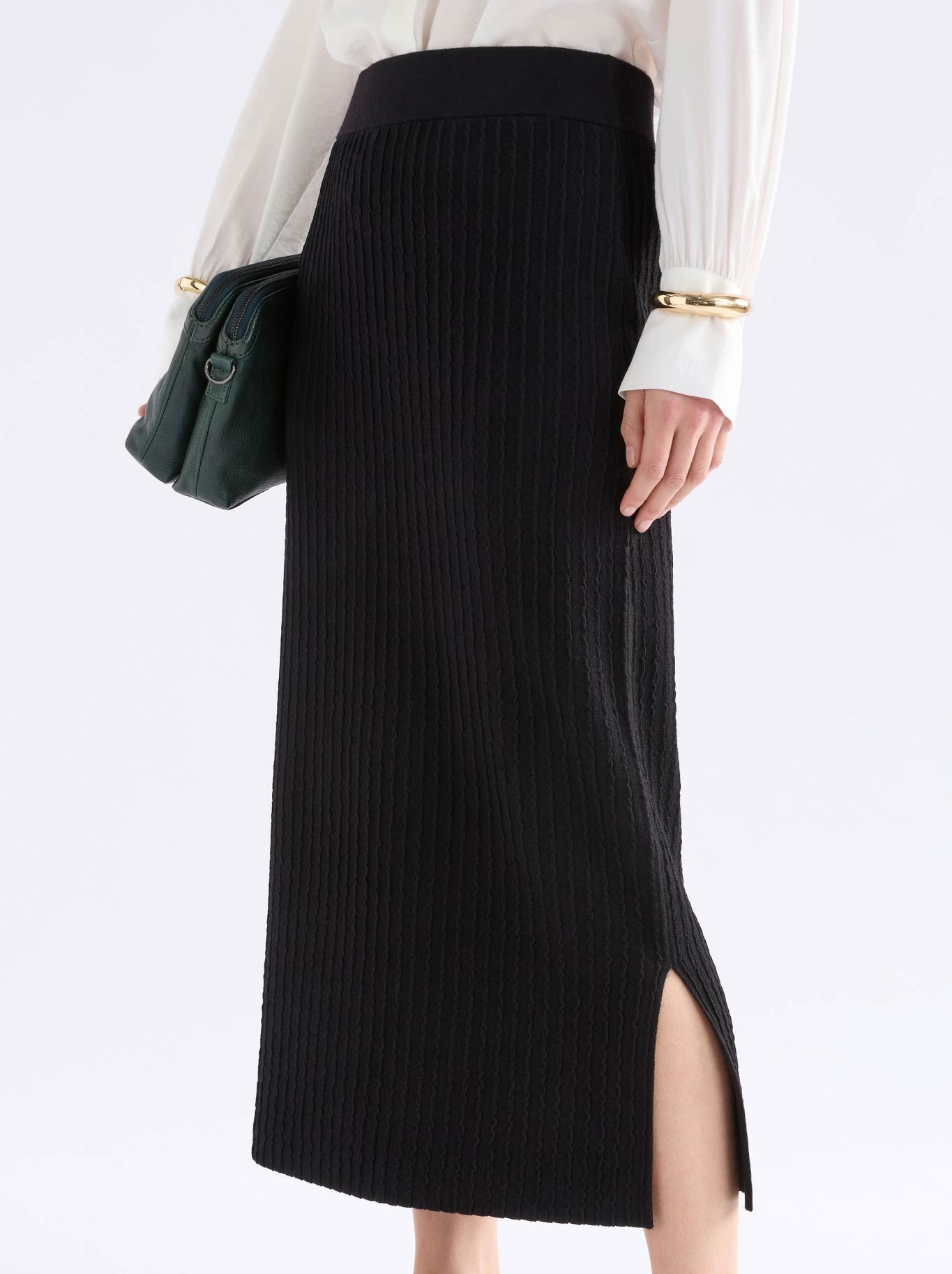Image of a model wearing Skirts. Product name - Elk Beim Knit Skirt in Black colour by brand - Elk