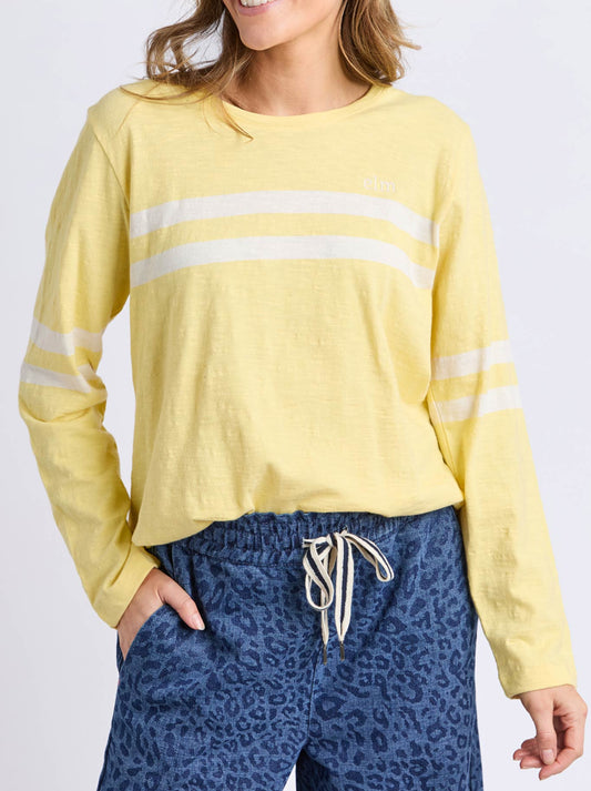 Image of a model wearing Tops. Productname: Elm Adora Long Sleeve Tee in Pale Lemon colour by brand - Elm