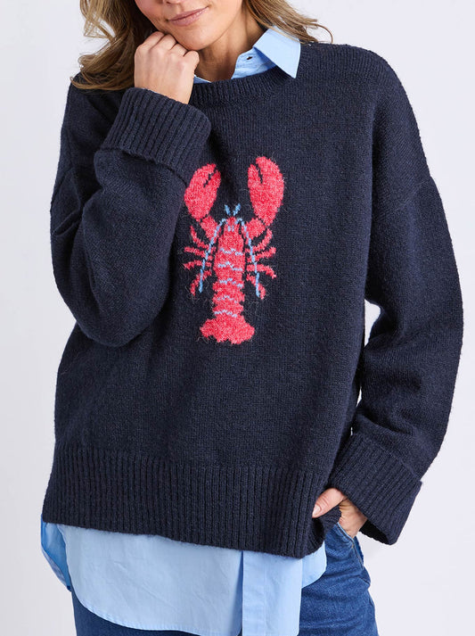 Image of a model wearing Tops. Productname: Elm Lobster Intersaid Knit in Navy A colour by brand - Elm