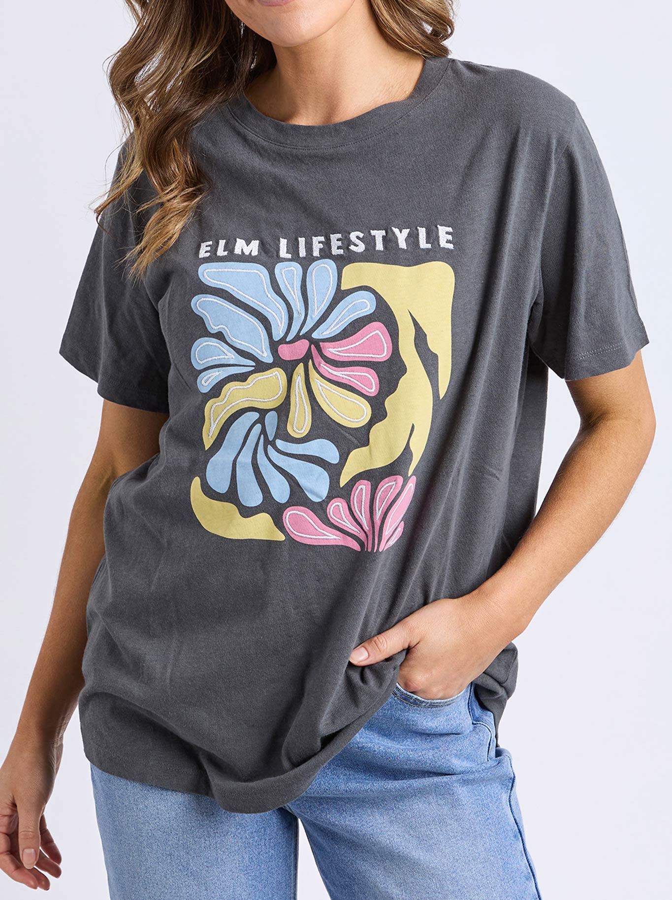 Image of a model wearing Tops. Productname: ELM LULU TEE in Washed Black colour by brand - Elm