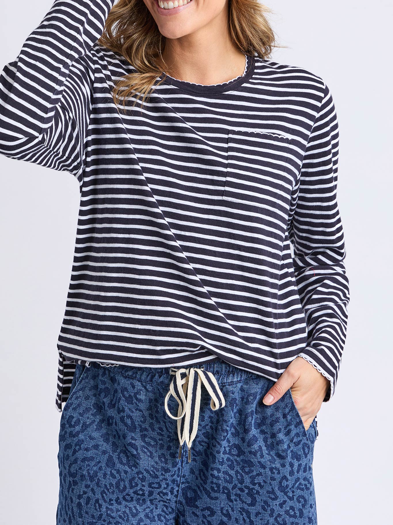 Image of a model wearing Tops. Productname: ELM DREA LONG SLEEVE TEE in Navy White Stripe colour by brand - Elm