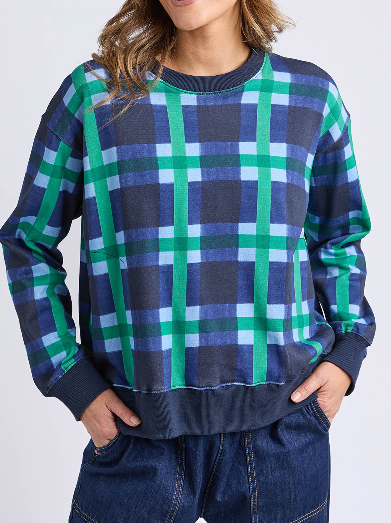 Image of a model wearing Tops. Productname: Elm Bari Crew in Blue Check colour by brand - Elm