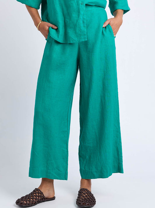 Image of a model wearing Pants. Product name - Elm Linen Holiday Pant in Irish Green colour by brand - Elm