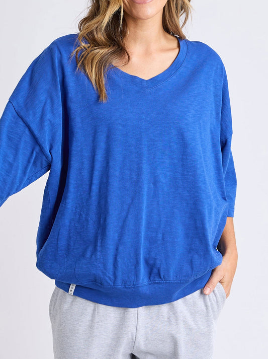 Image of a model wearing Tops. Productname: Elm Mazie V Neck in French Blue colour by brand - Elm