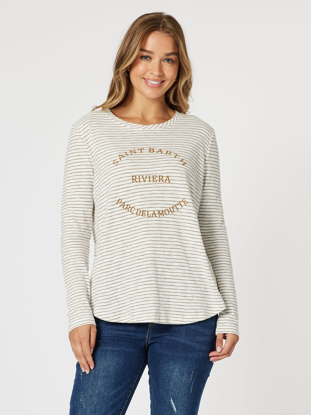 Image of a model wearing Tops. Product name - Riviera Long Sleeve Stripe Print Tee Natural/White in Natural/White colour by brand - Threadz