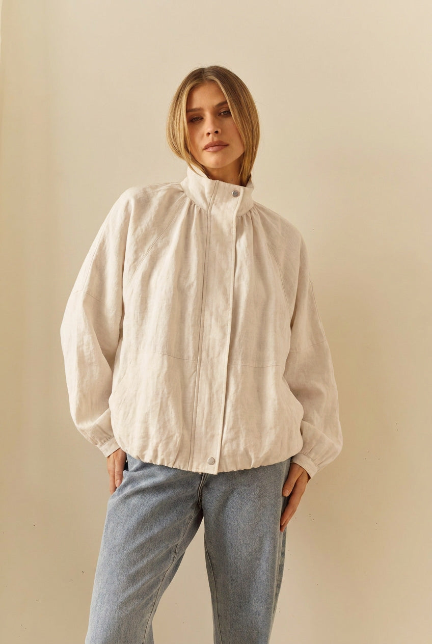 Image of a model wearing Outerwear. Product name - Emma Batwing Bomber in Cream colour by brand - Sass Clothing