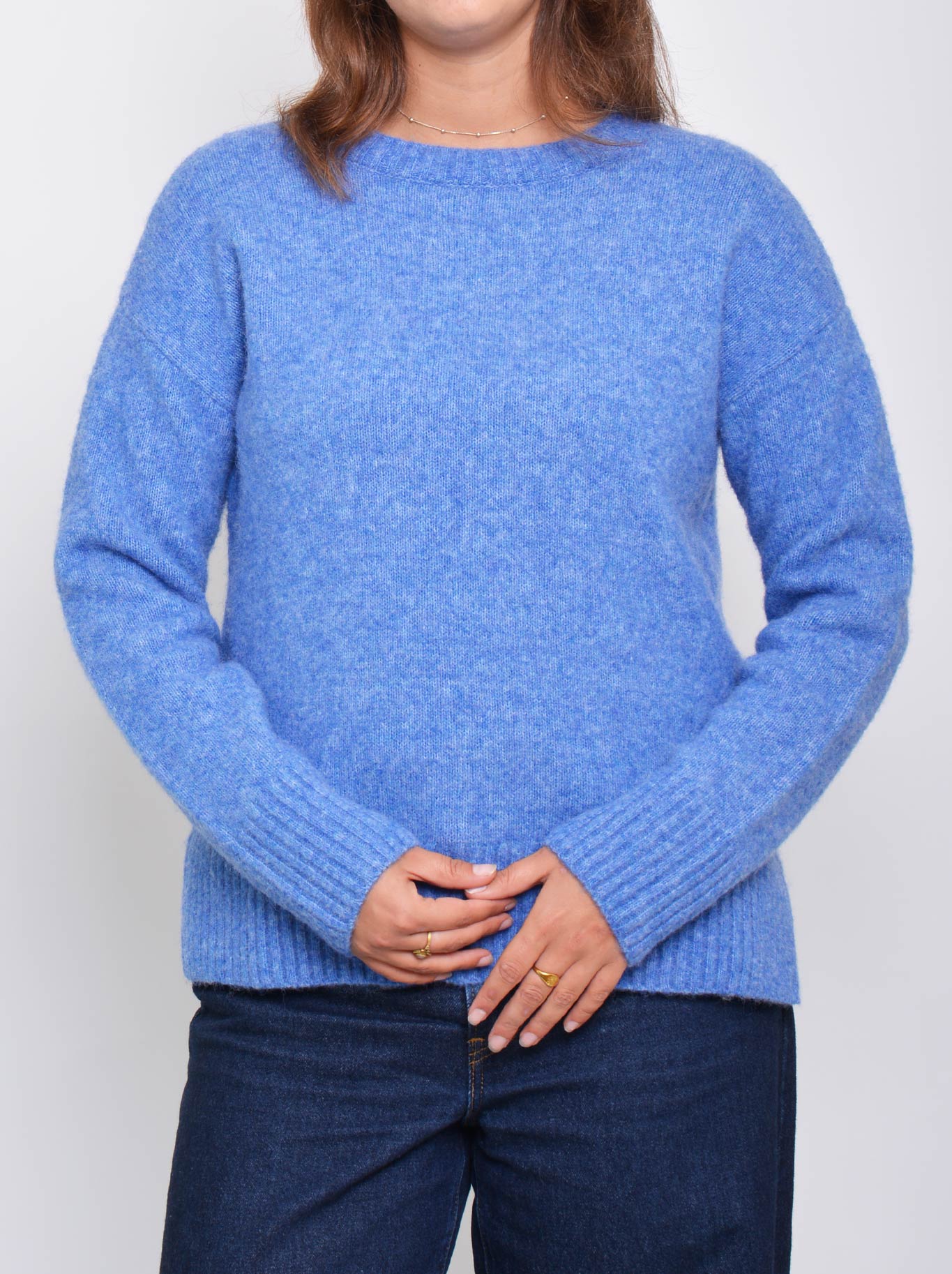 Image of a model wearing Outerwear. Product name - Enni Crew Knit in Blue colour by brand - Enni