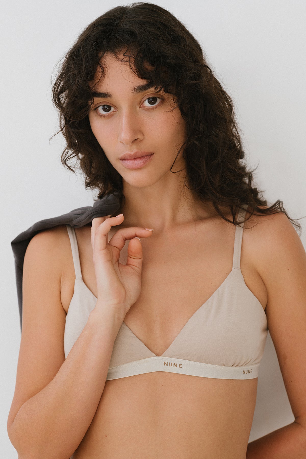 Image of a model wearing Tops. Product name - Triangle Bralette Latte in Latte colour by brand - NUNE