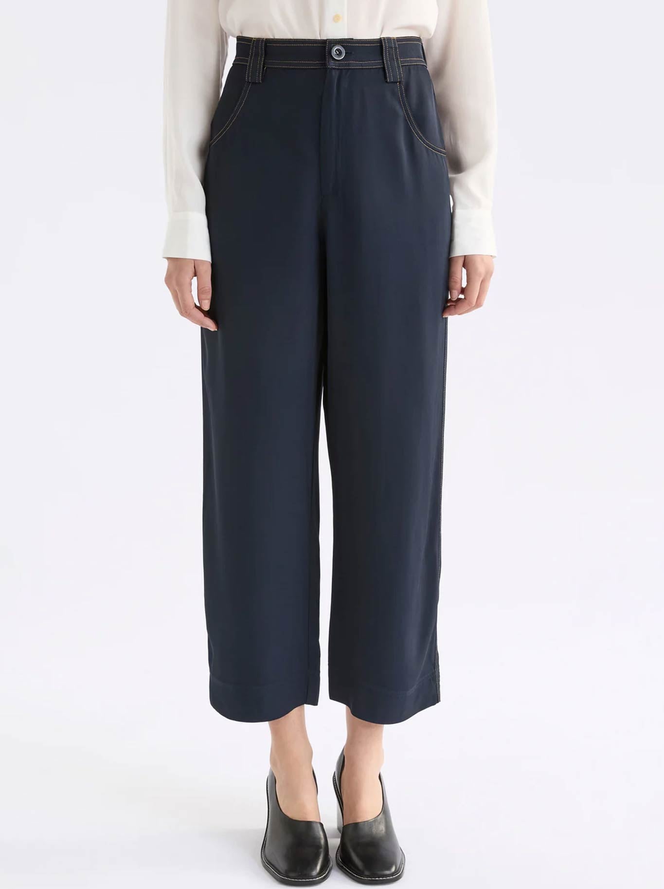 Image of a model wearing Pants. Product name - Elk Hullu Pant in Navy colour by brand - Elk