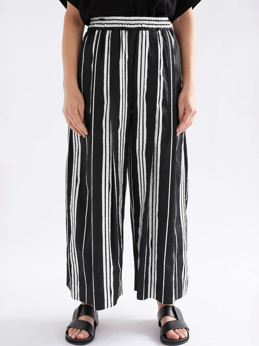 Image of a model wearing Pants. Productname: ELK REZA PANT in Fez Print Black colour by brand - Elk