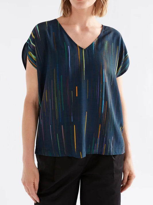 Image of a model wearing Tops. Productname: ELK KAYRA V NECK TOP in Alinea Print colour by brand - Elk
