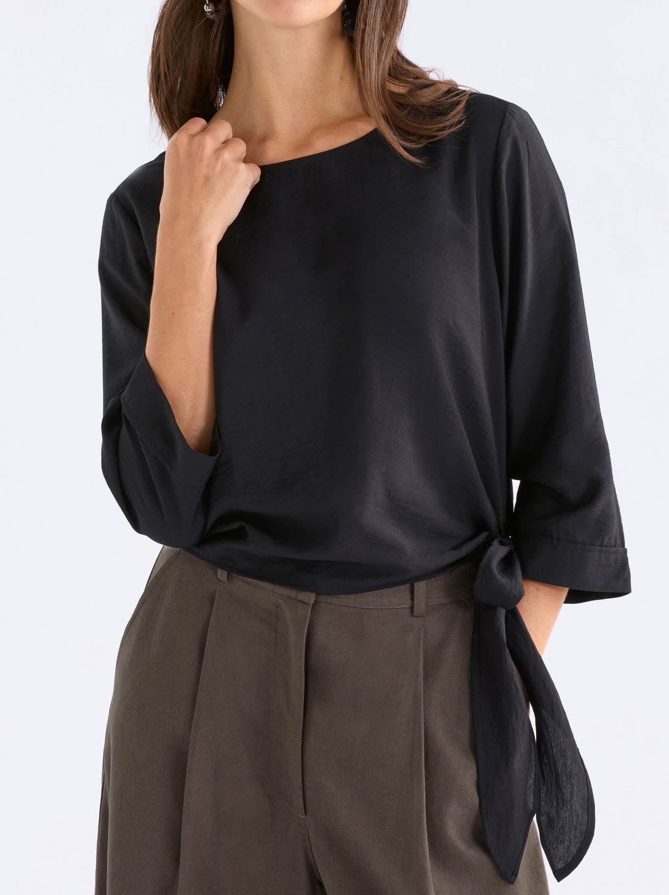Image of a model wearing Tops. Product name - Elk Rema Top in Black colour by brand - Elk
