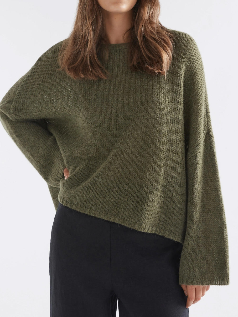 Image of a model wearing Outerwear. Product name - ELK AGNA SWEATER in Dark Olive colour by brand - Elk