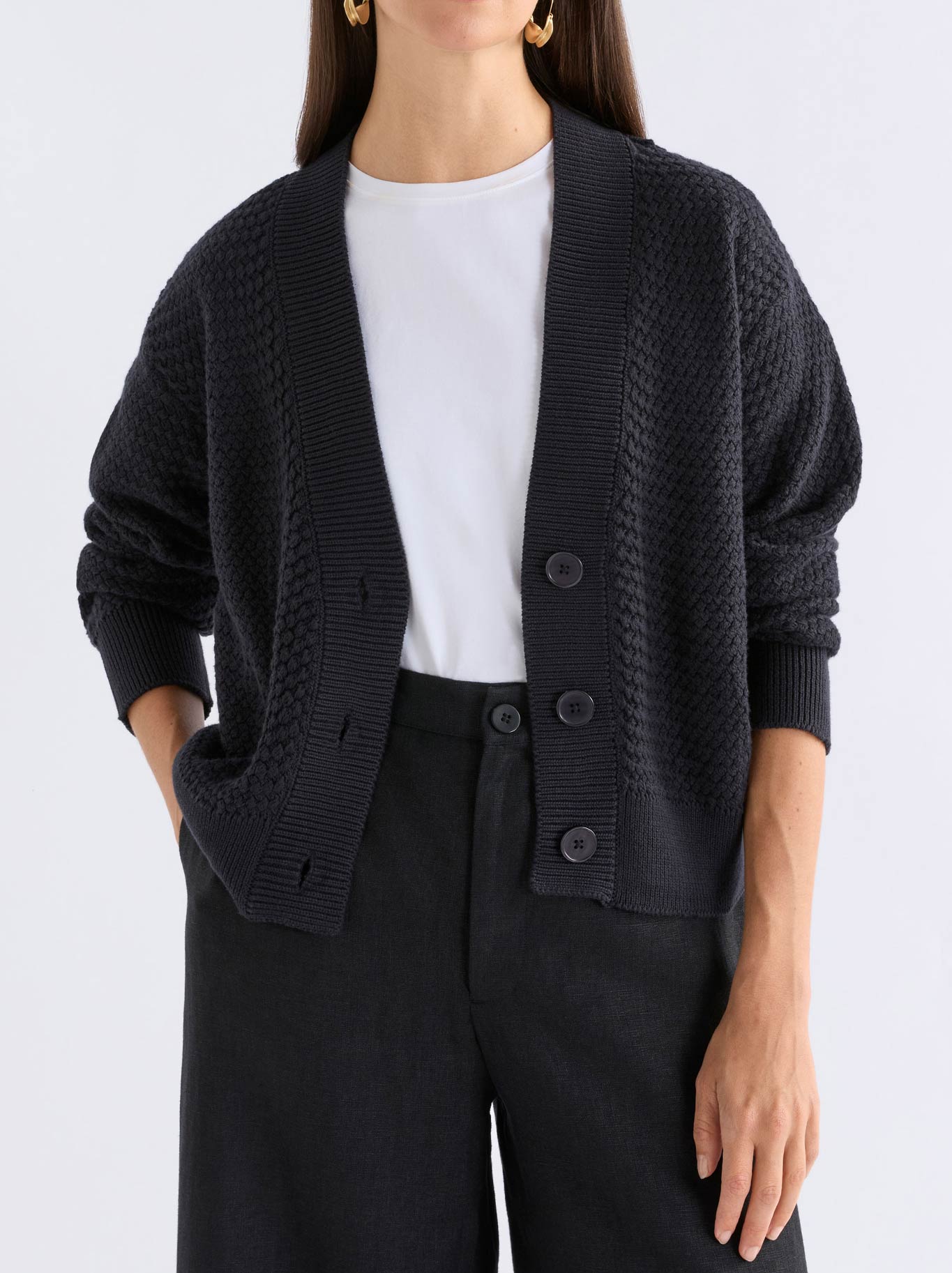 Image of a model wearing Outerwear. Product name - Elk Naya Cardigan in Black colour by brand - Elk
