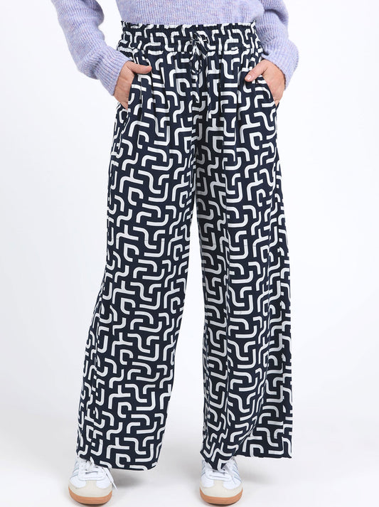 Image of a model wearing Pants. Productname: ELM GEMMA GEO PANT in Geo colour by brand - Elm
