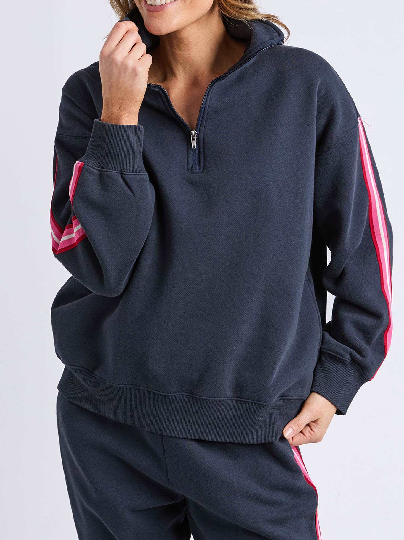 Image of a model wearing Tops. Product name - ELM LOVER 1/4 ZIP CREW in Navy A colour by brand - Elm