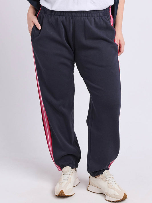 Image of a model wearing Pants. Product name - Elm Lover Trackpant in Navy A colour by brand - Elm