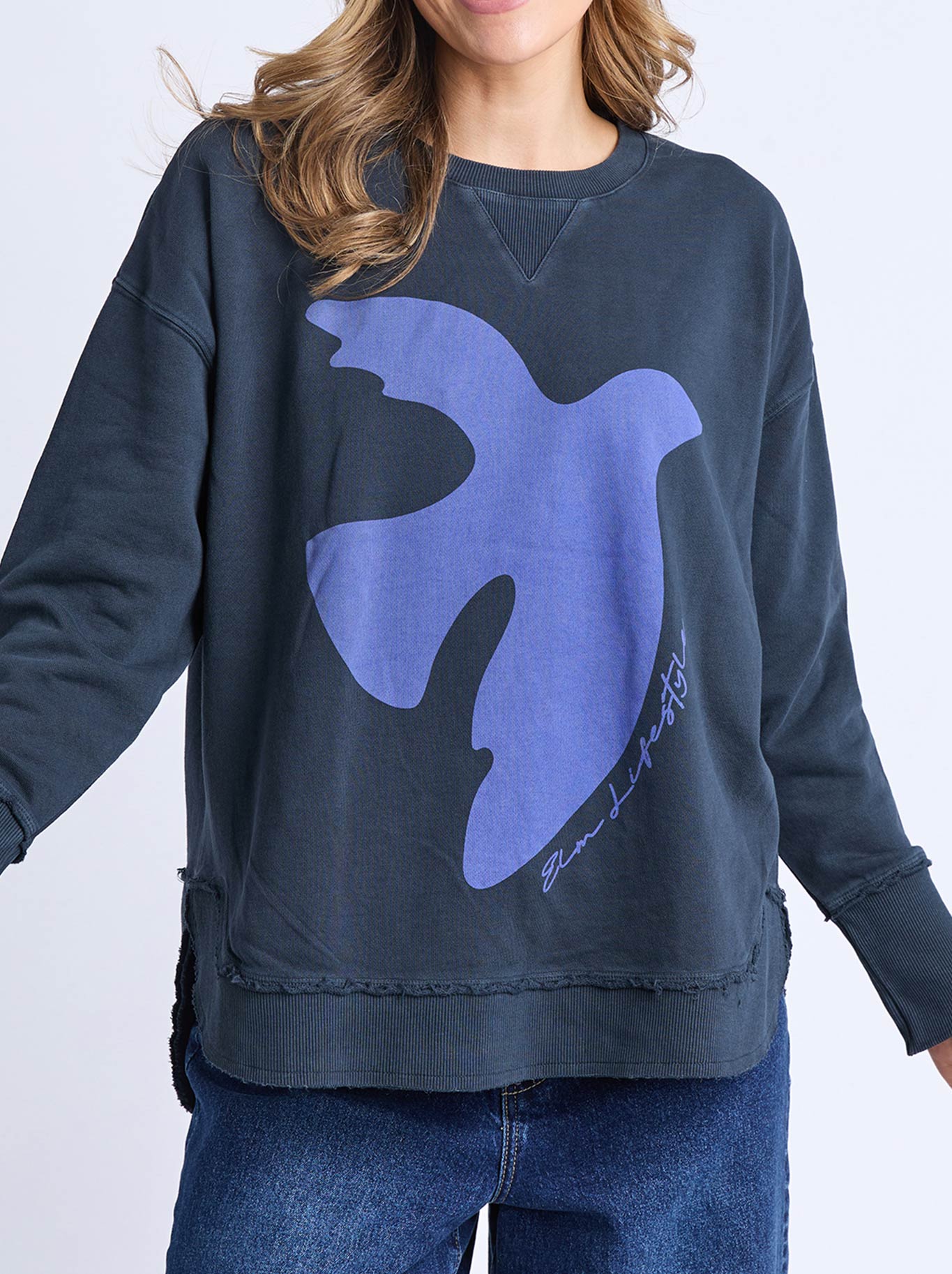 Image of a model wearing Tops. Product name - ELM LOVIISA CREW in Navy colour by brand - Elm
