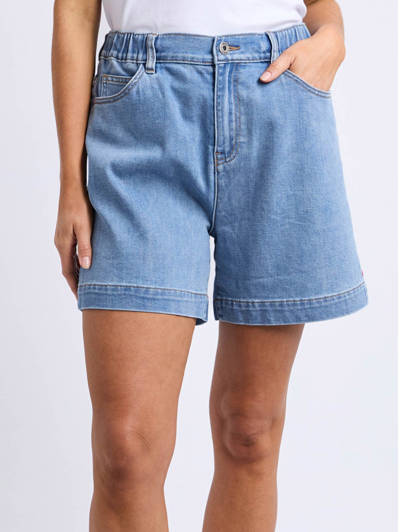 Image of a model wearing Shorts. Product name - ELM BIRDIE DENIM SHORT in Lightwash colour by brand - Elm