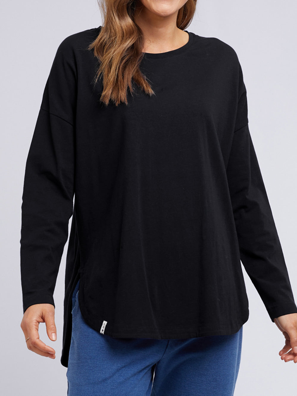 Image of a model wearing Tops. Productname: ELM SOCIETY LONG SLEEVE TEE in White colour by brand - Elm