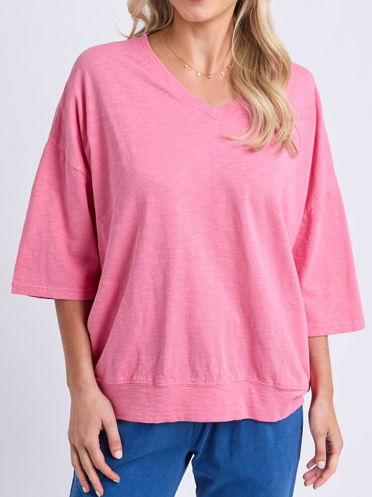 Image of a model wearing Tops. Product name - ELM MAZIE V NECK in Pink Lemonade colour by brand - Elm