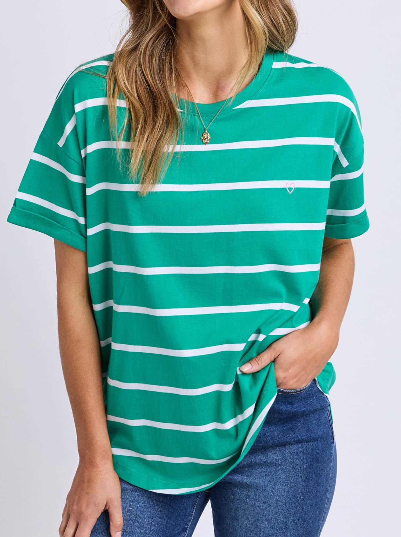Image of a model wearing Tops. Product name - ELM HALLI SHORT SLEEVE TEE in Virdis Green colour by brand - Elm