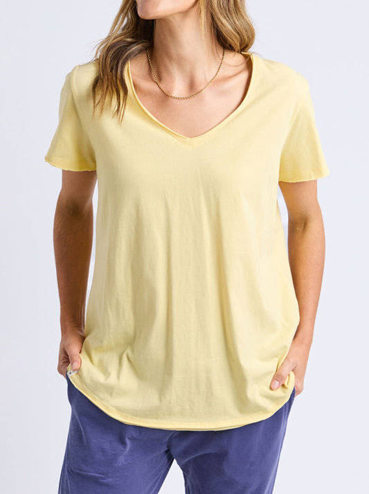 Image of a model wearing Tops. Product name - ELM PIMA VEE TEE in Banana colour by brand - Elm