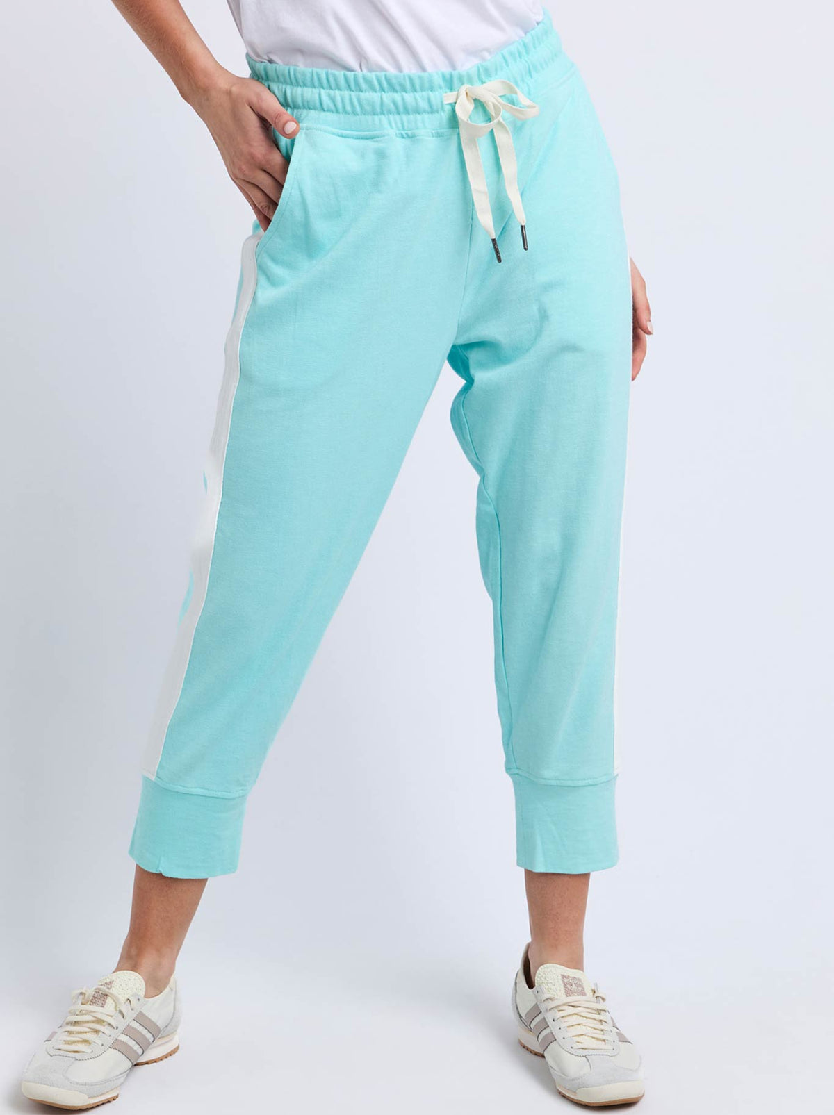 Image of a model wearing Pants. Product name - Elm Brunch Pant With Side Tape in Tonic Blue/White colour by brand - Elm