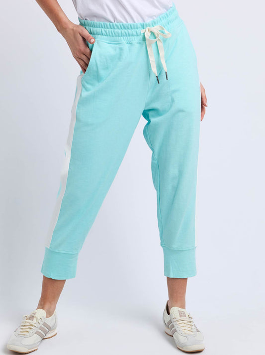 Image of a model wearing Pants. Product name - Elm Brunch Pant With Side Tape in Tonic Blue/White colour by brand - Elm